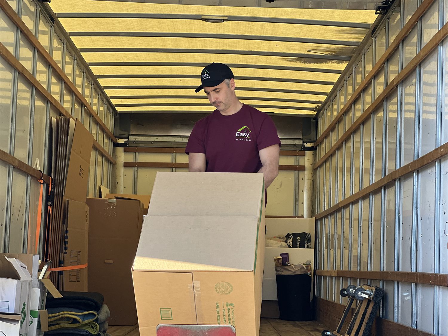 Easy Moving LA mover organizing boxes in a truck for transport